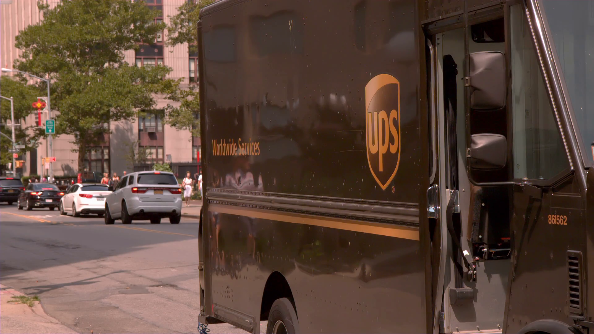 UPS trucks on city streets